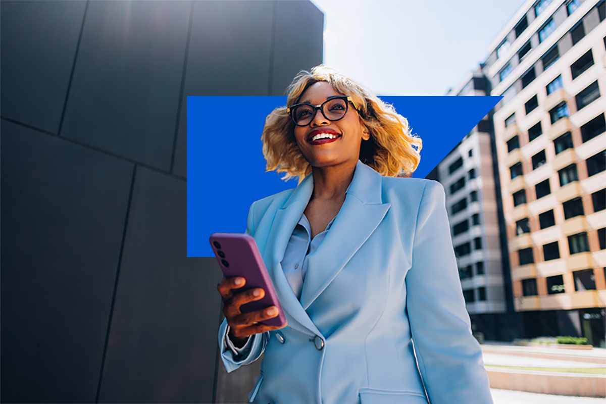 Lady wearing blue suit in city with her mobile device