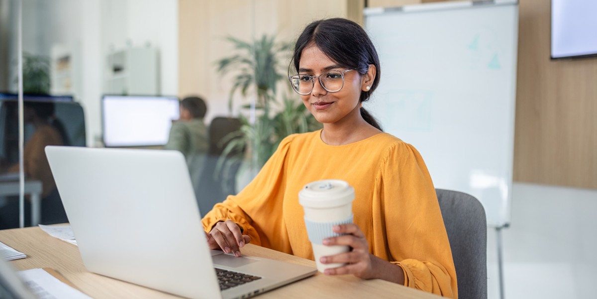 woman with coffee at laptop
