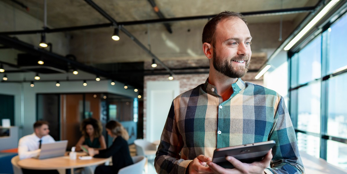 smiling man with tablet