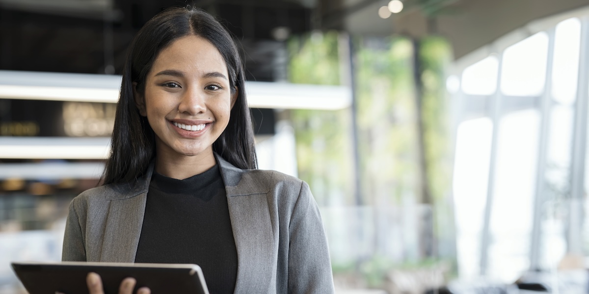 woman holding ipad smiling