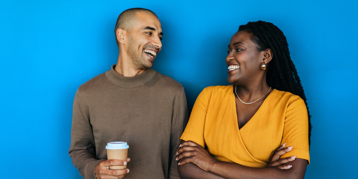 Man and woman looking at each other smiling and laughing