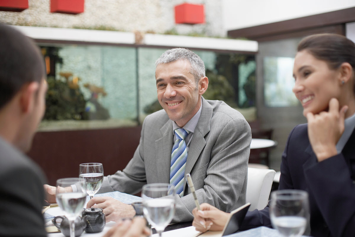 Business people smiling at table