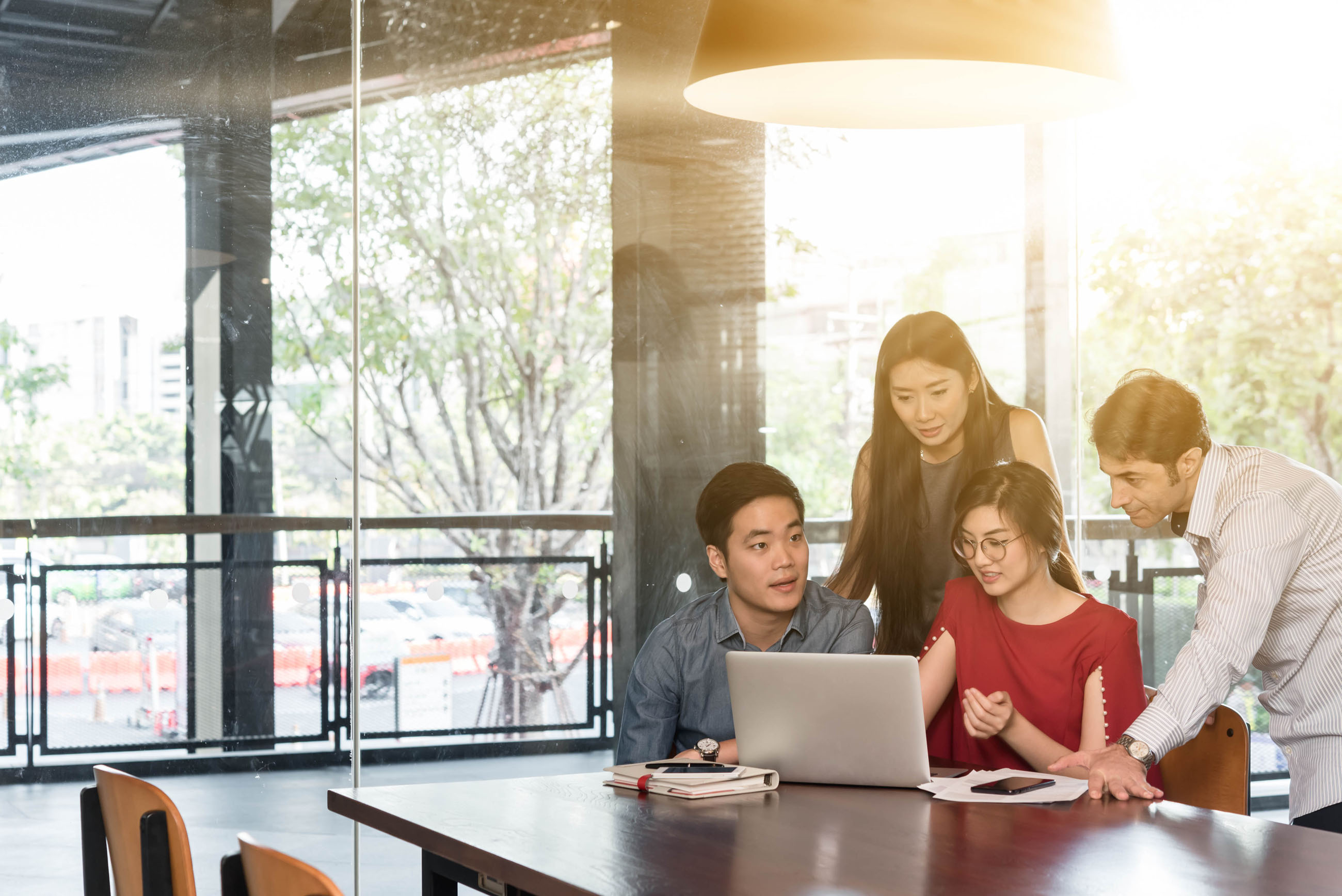 Young business people looking at laptop