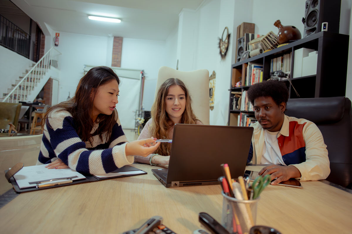 Young business people looking at laptop
