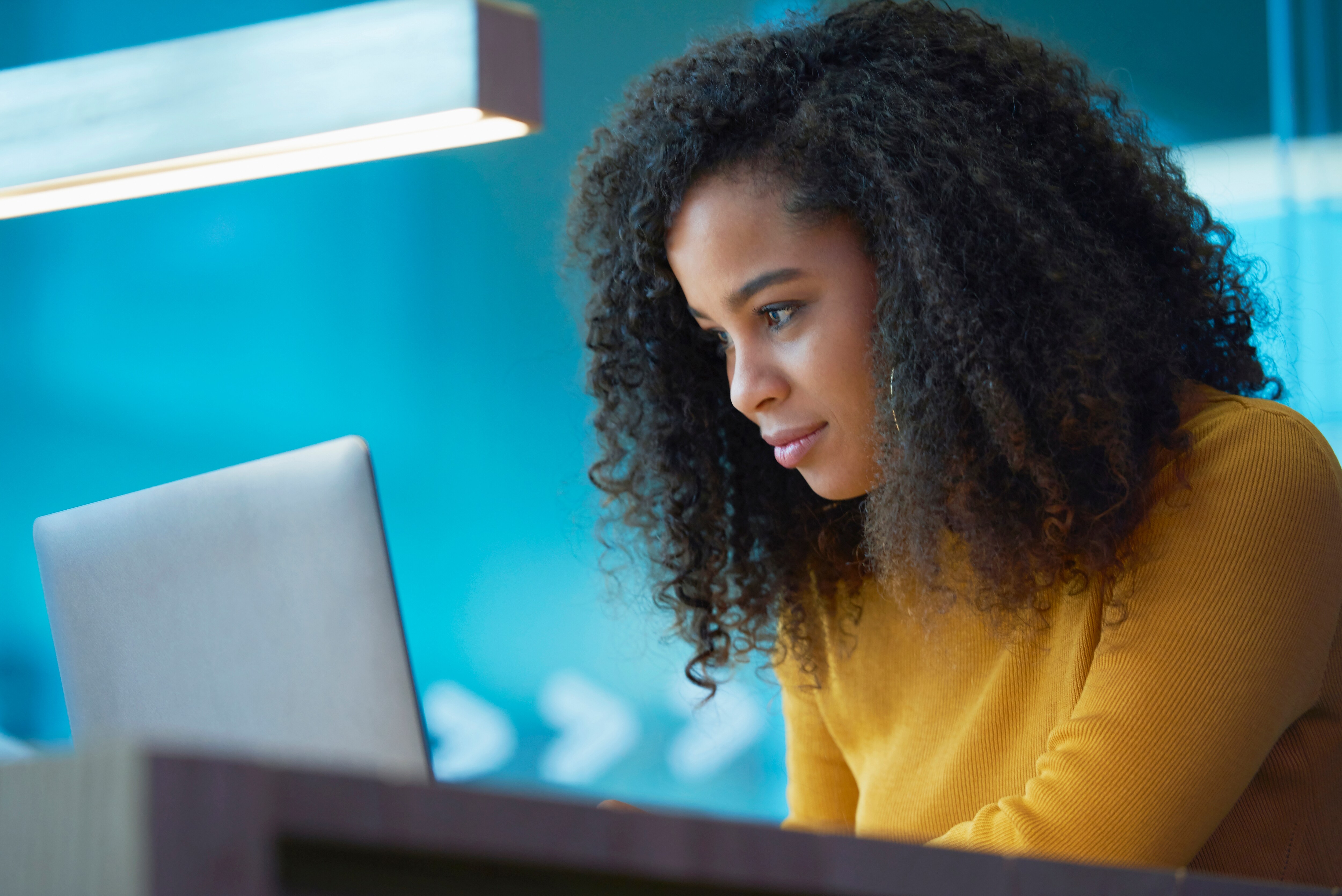 young woman working on laptop at table
