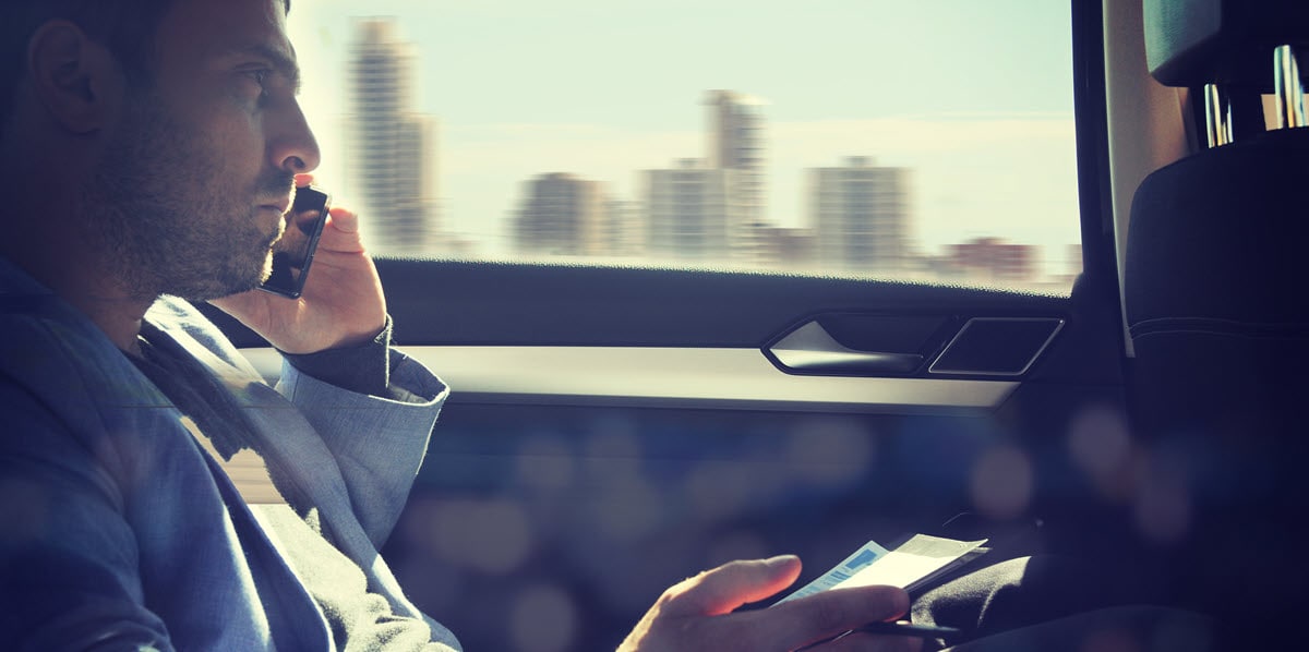 traveler in car using cell phone