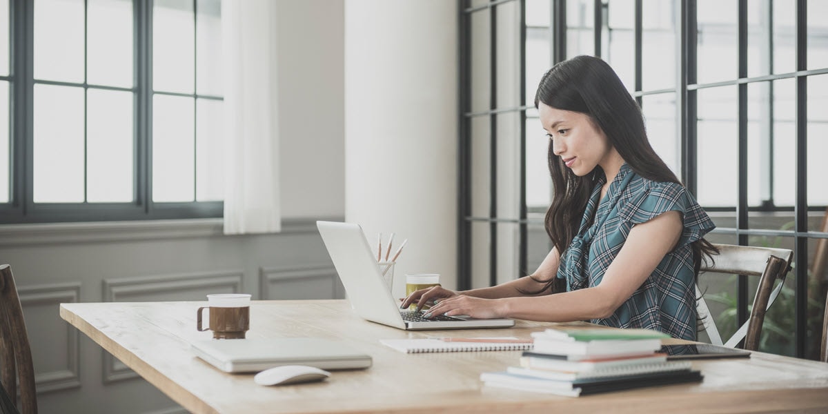 young woman working on laptop at table