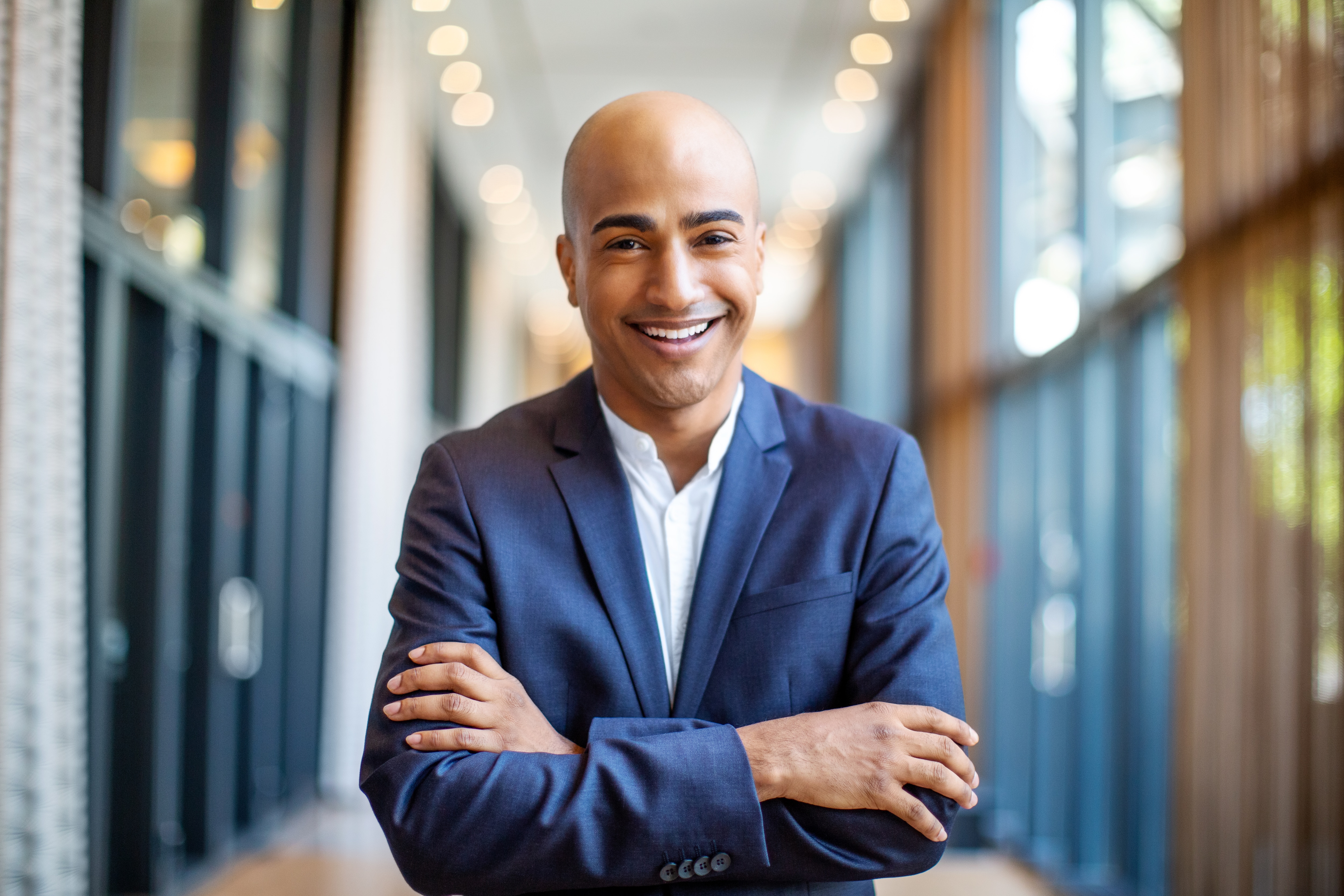 Man smiling in the hallway of a hospital because he uses SAP Concur