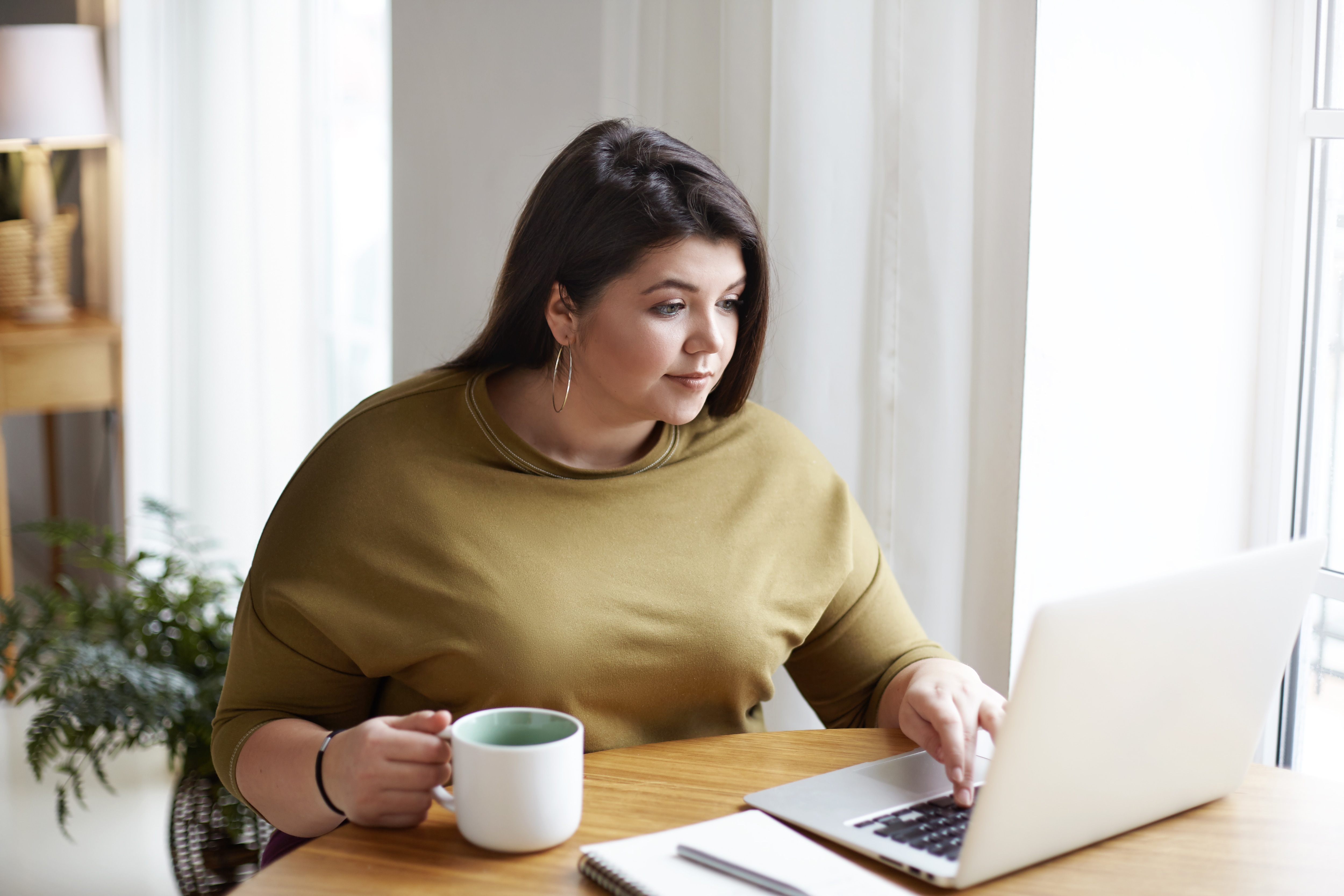 a woman looking at the laptop