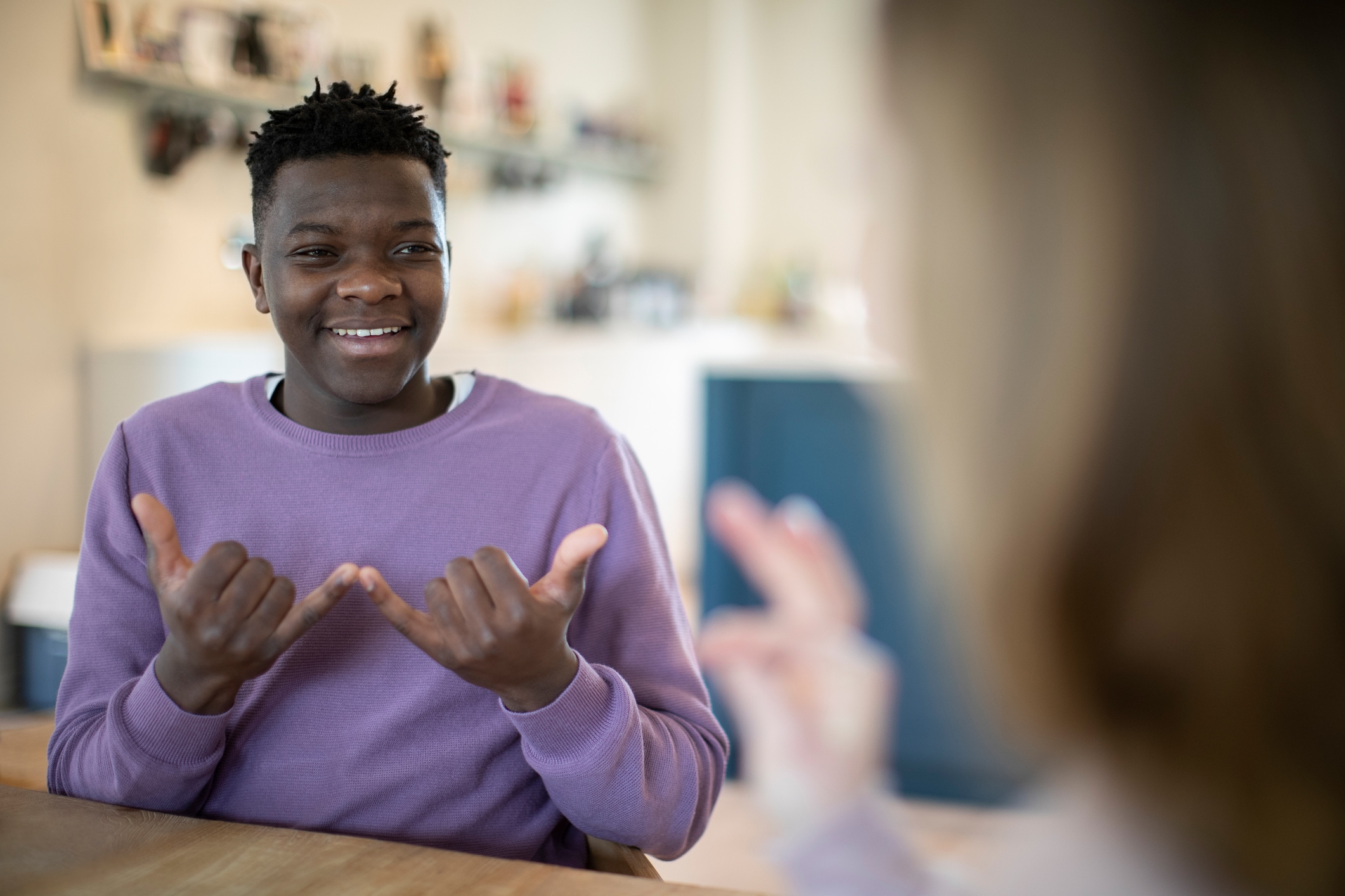 Person in purple sweater smiling