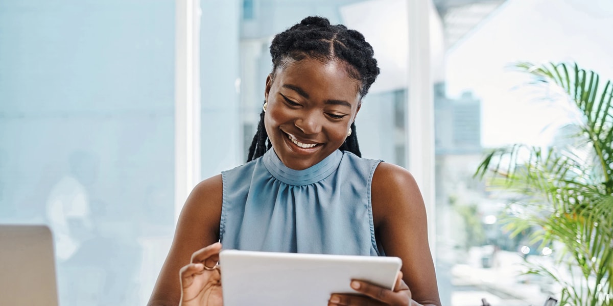 Woman smiling looking at tablet