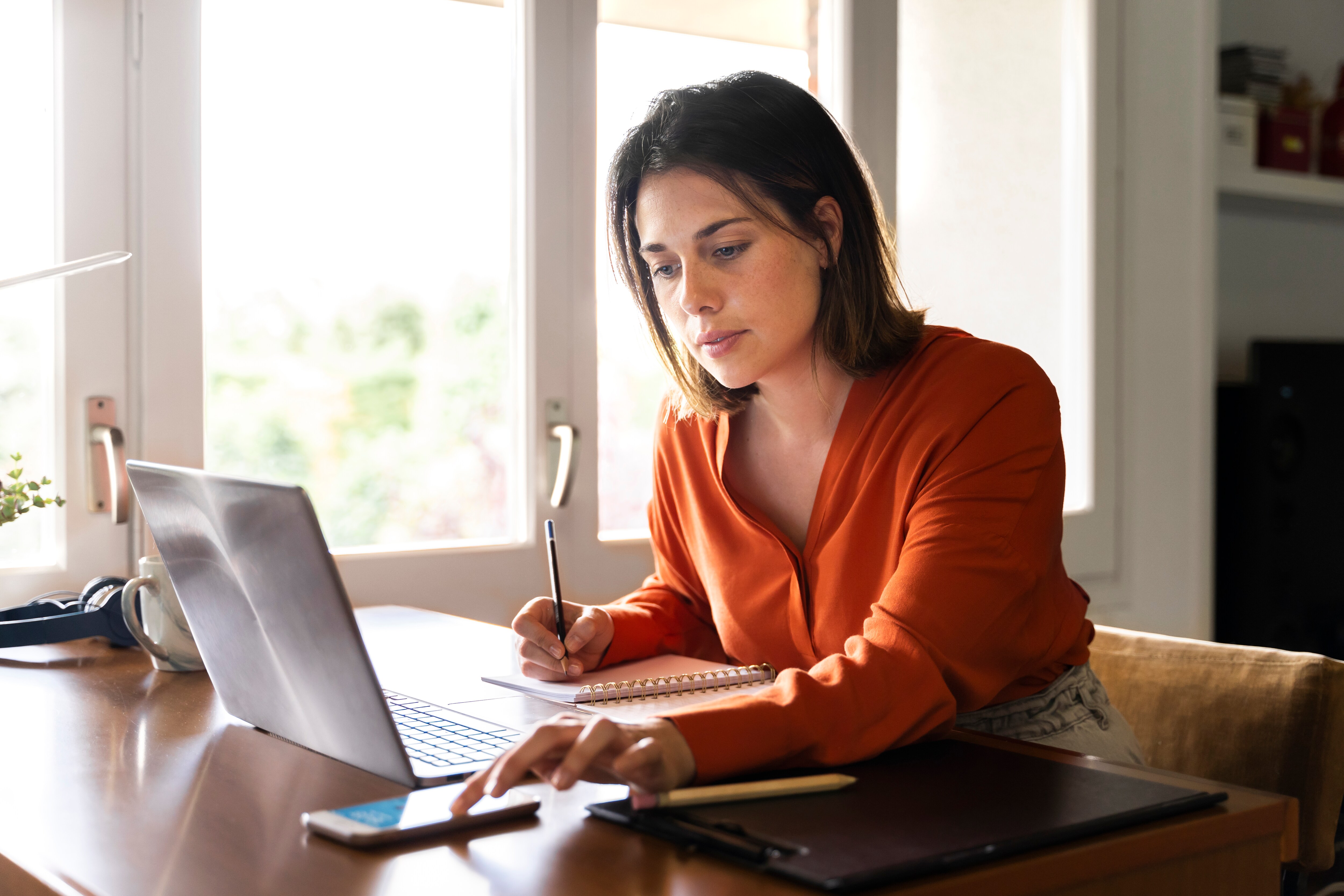 accounts payable professional working at computer and using phone