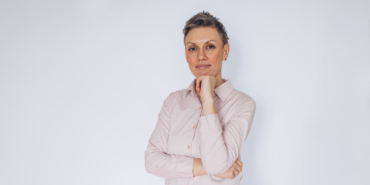 woman with short hair resting hand on chin