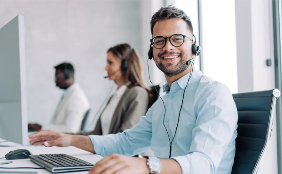 Person wearing a headset sitting at a computer