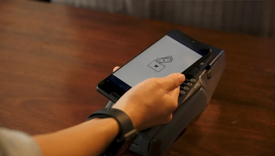 Person using a phone to pay