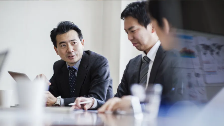 three people working in an office