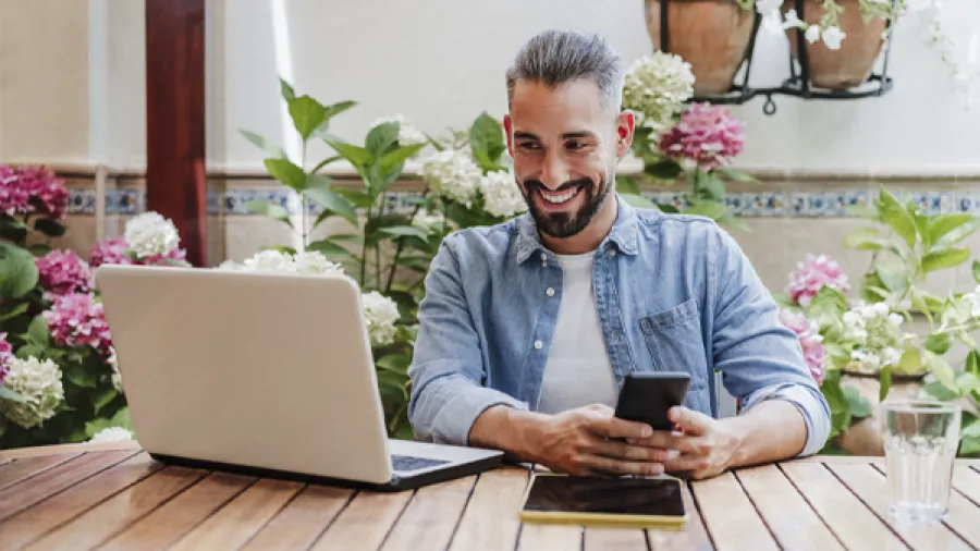 business professional at desk with devices