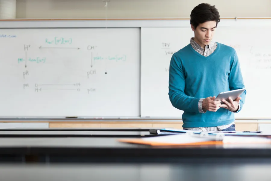 Male teacher in front of classroom