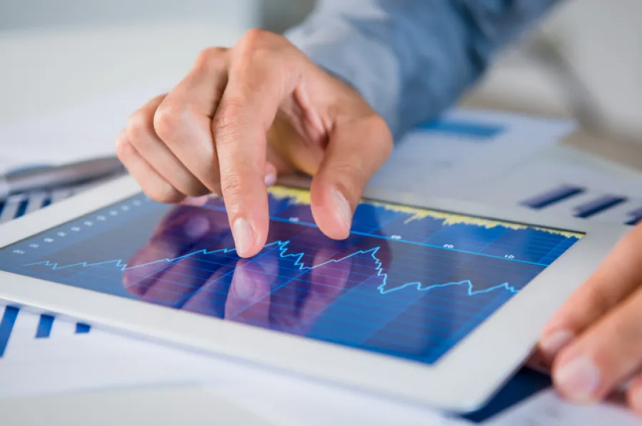 man looking at report on ipad