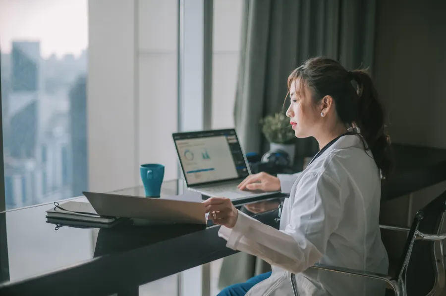 health professional sitting at a desk