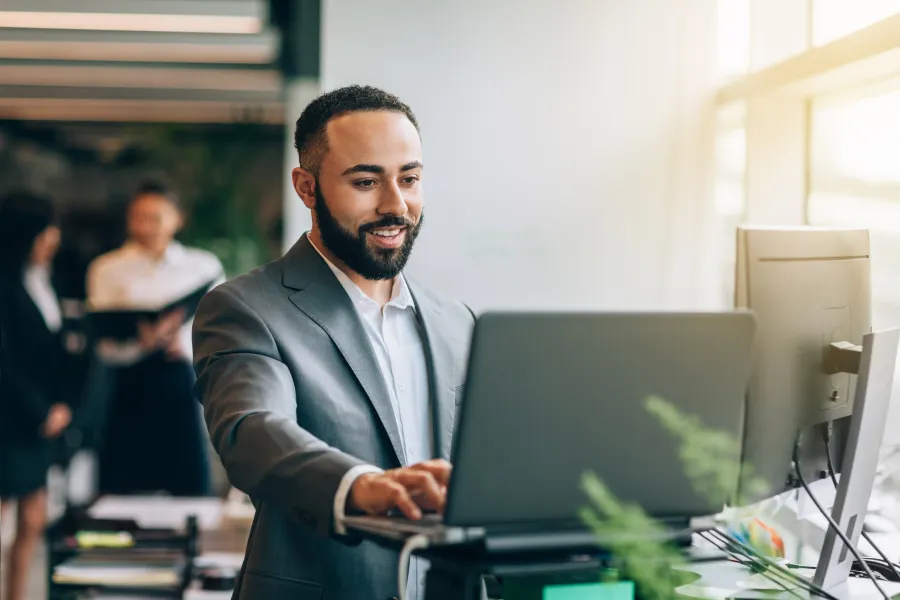 business professional at desk using laptop
