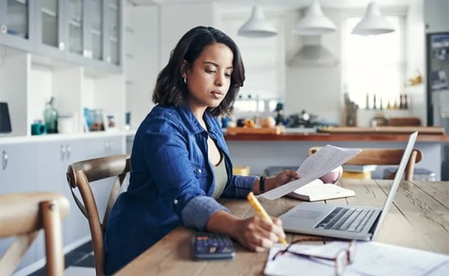 Woman with laptop and receipts