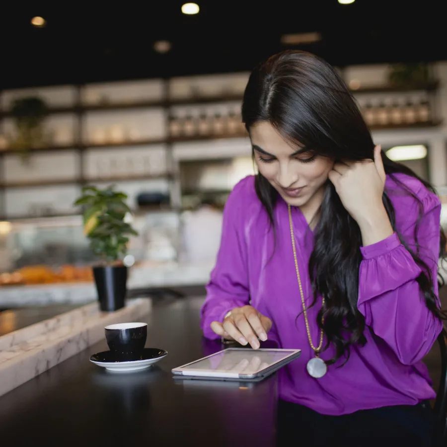 Woman using digital tablet at restaurant