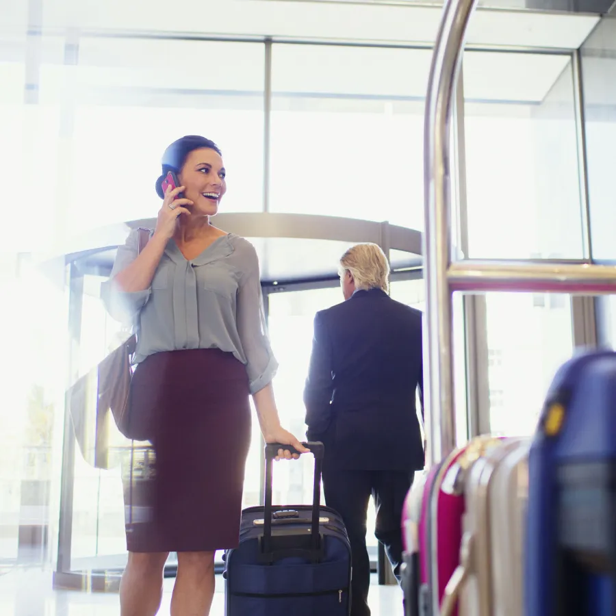 Business traveler walks into a hotel lobby