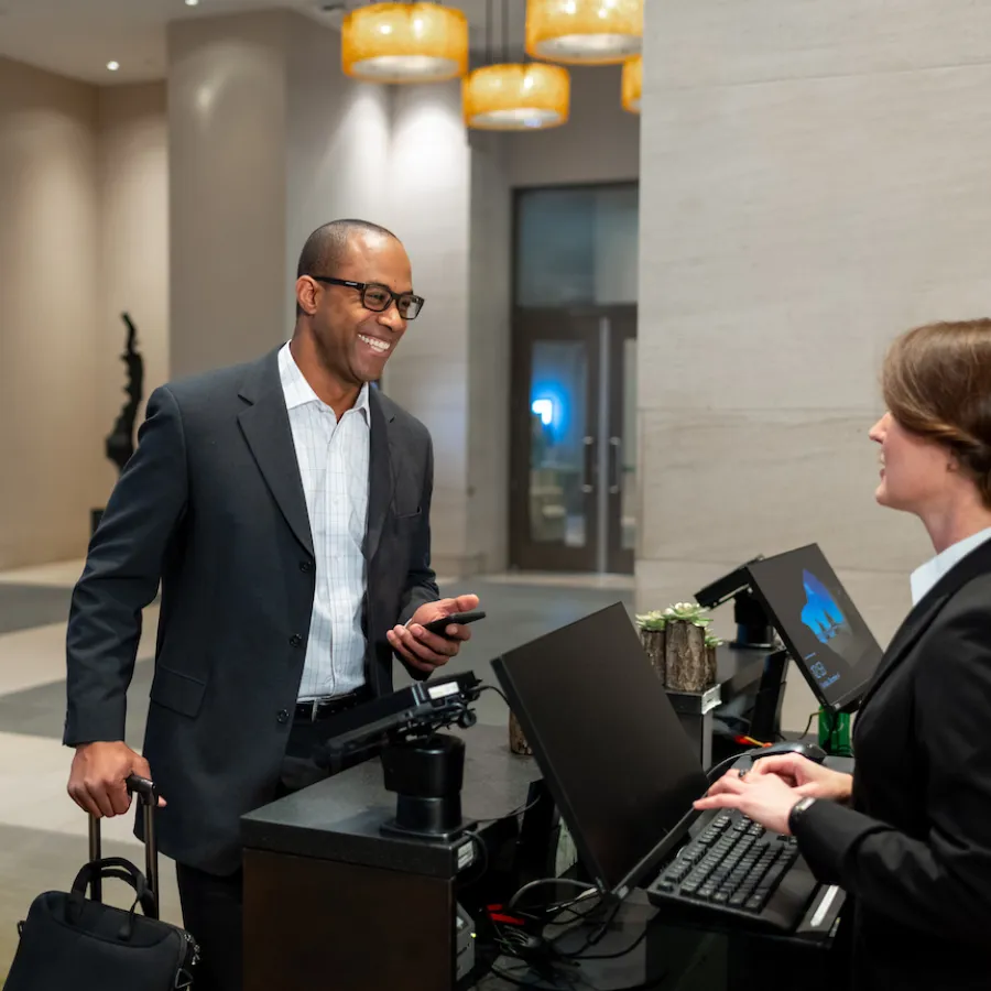 Business traveler checks in at a hotel