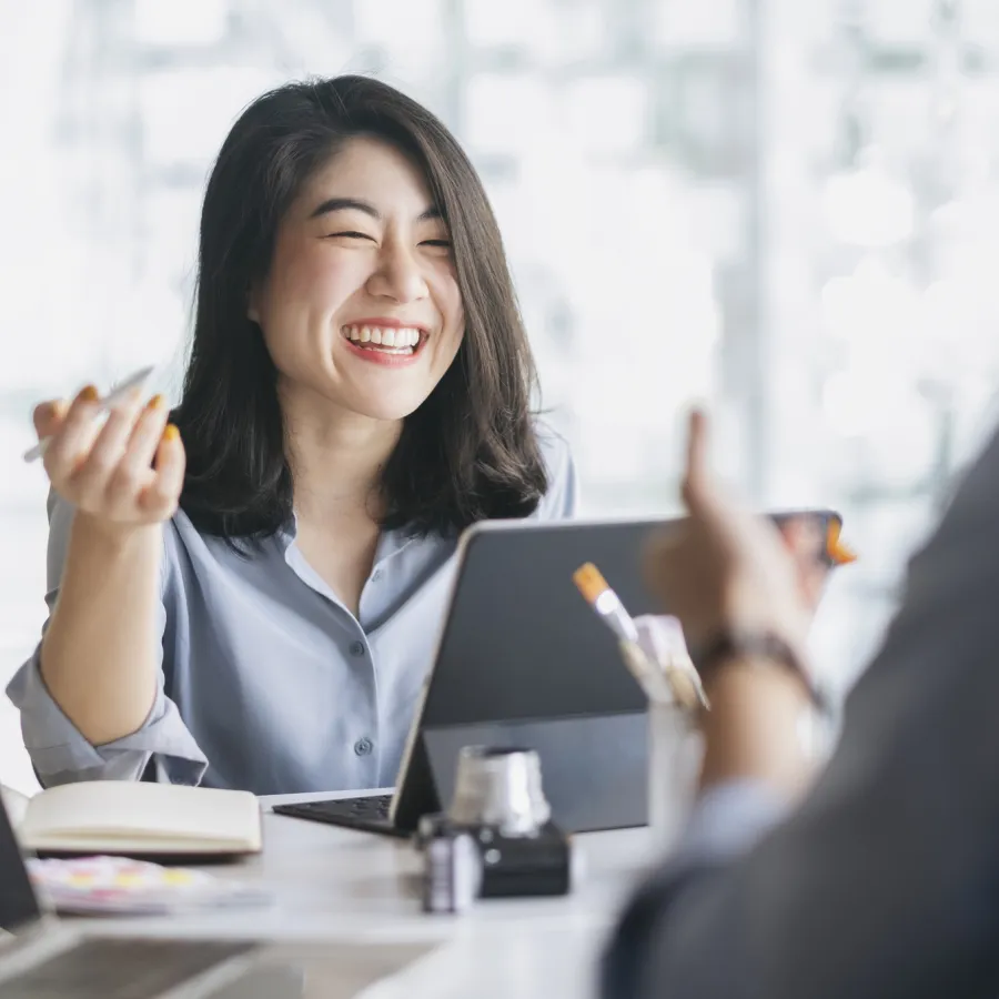 Happy woman meets with people in an office