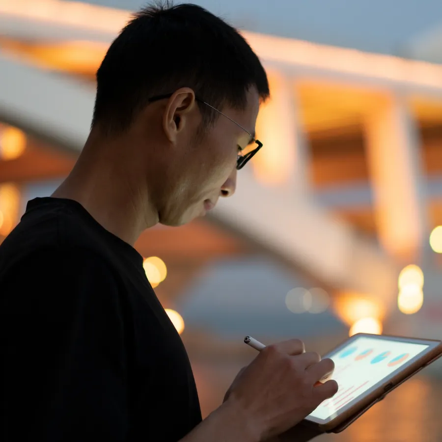 Man using tablet at night