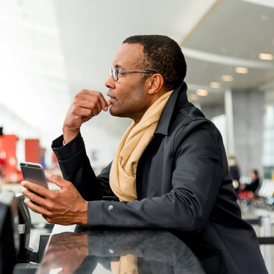 Traveler looking out the window at an airport