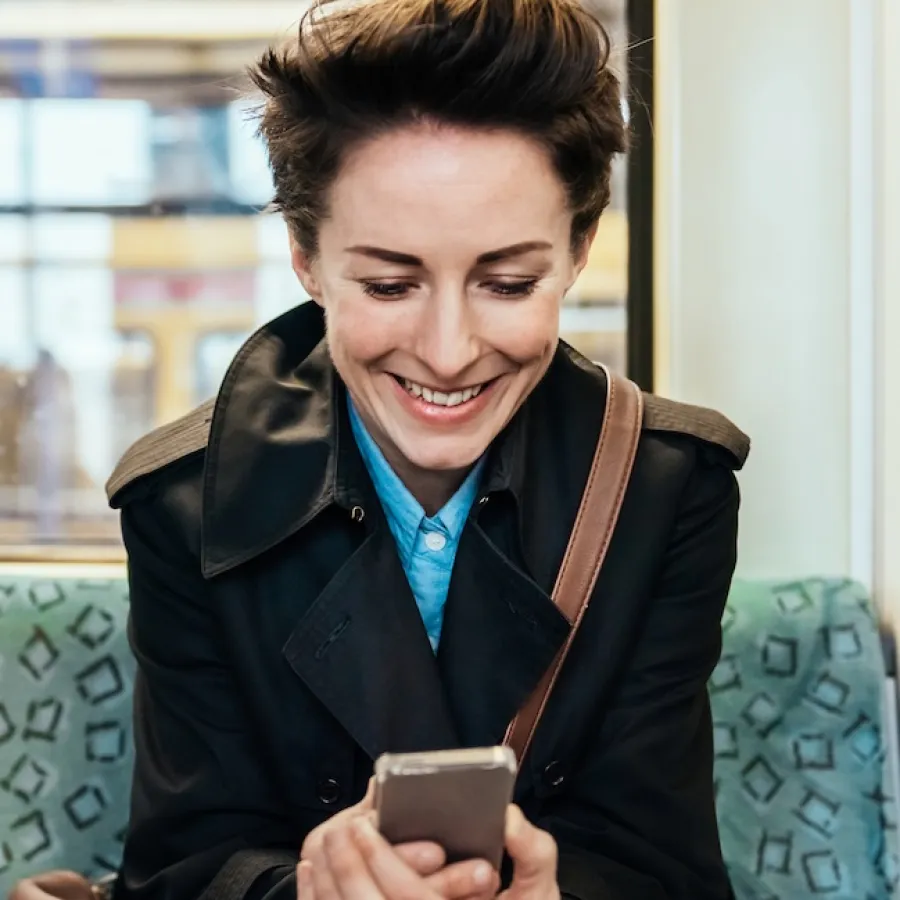 business traveler on a train looking at a mobile phone