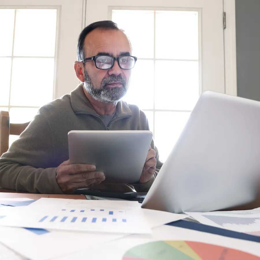 Man wearing glasses looking at papers