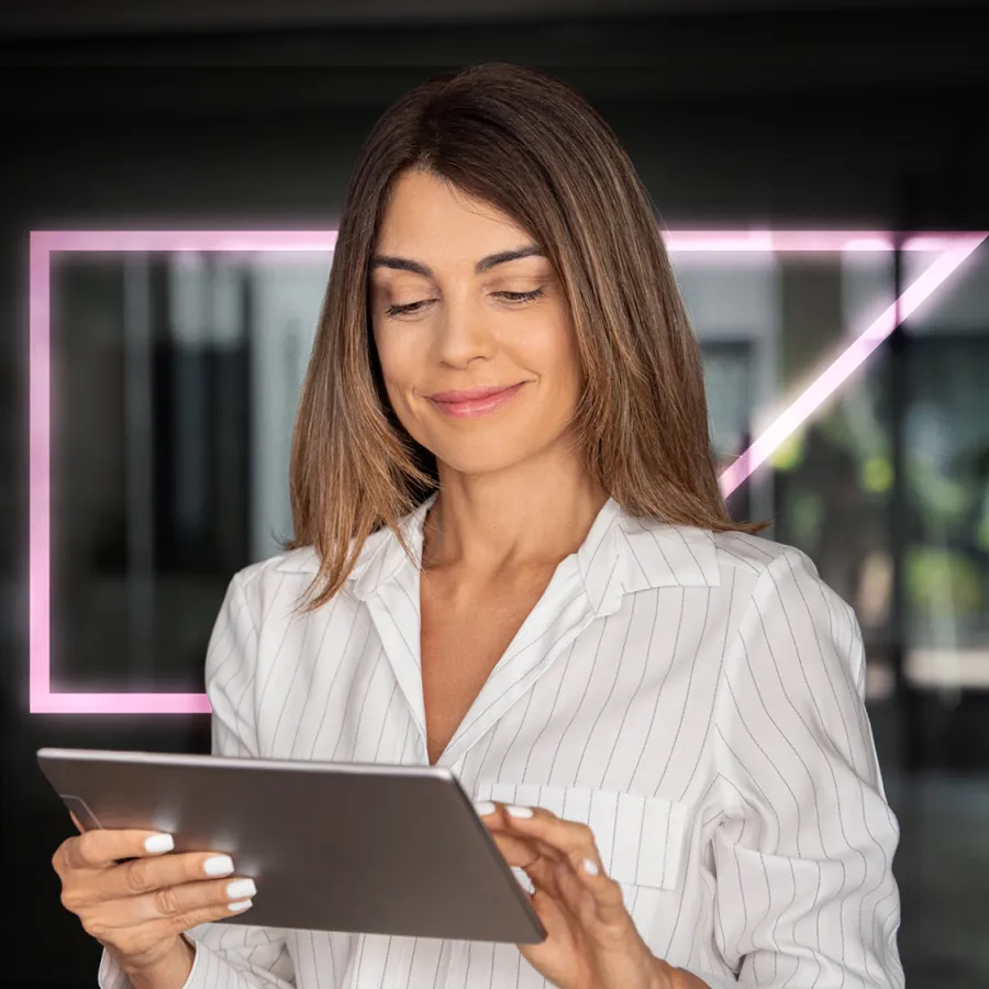 smiling woman looking at tablet