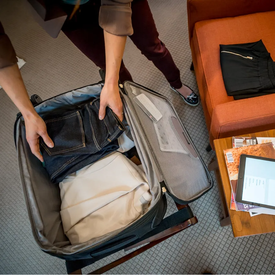 person packing suitcase for travel