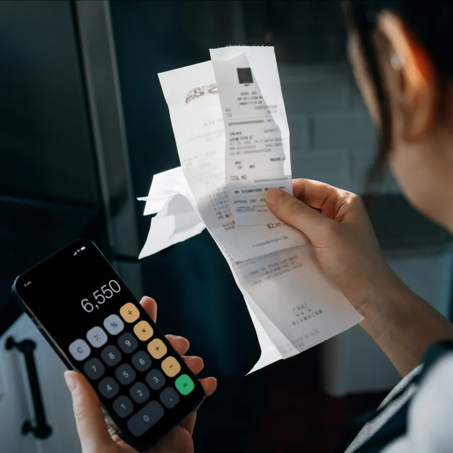Women looking at receipts for spend management