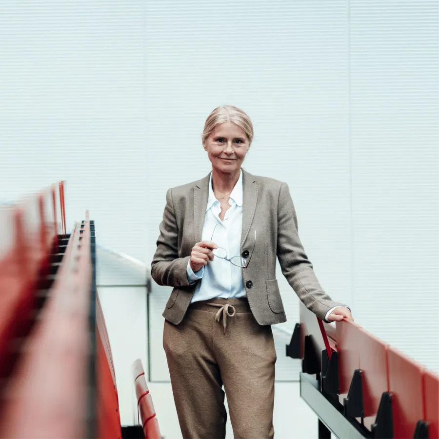 Woman standing in a university classroom