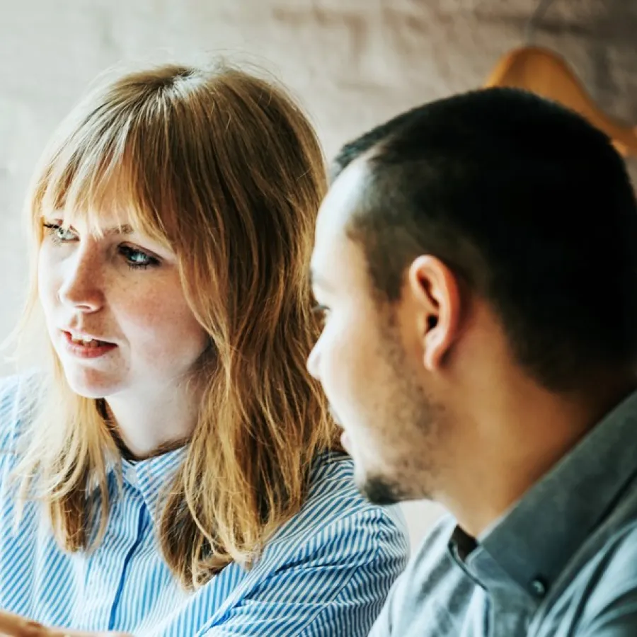 two people working at a computer together