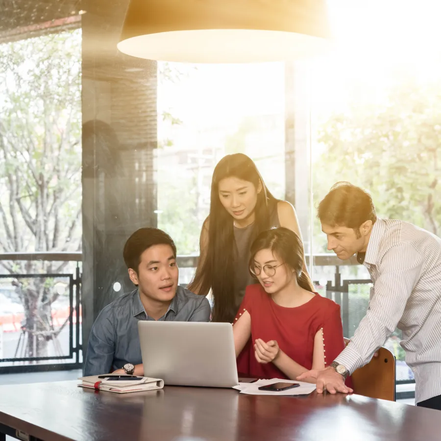 Group working together looking at a laptop