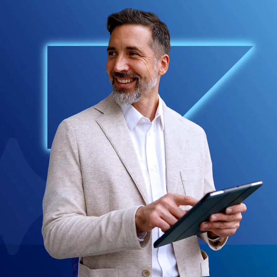 Smiling man looking away from tablet