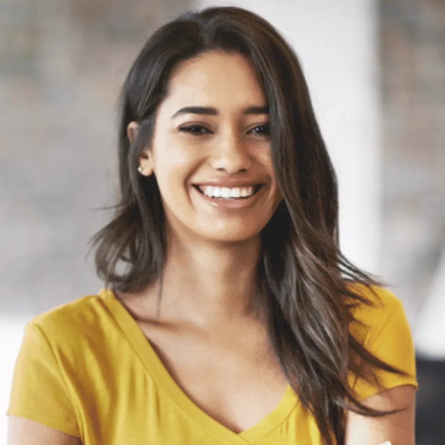smiling woman with dark hair in yellow shirt