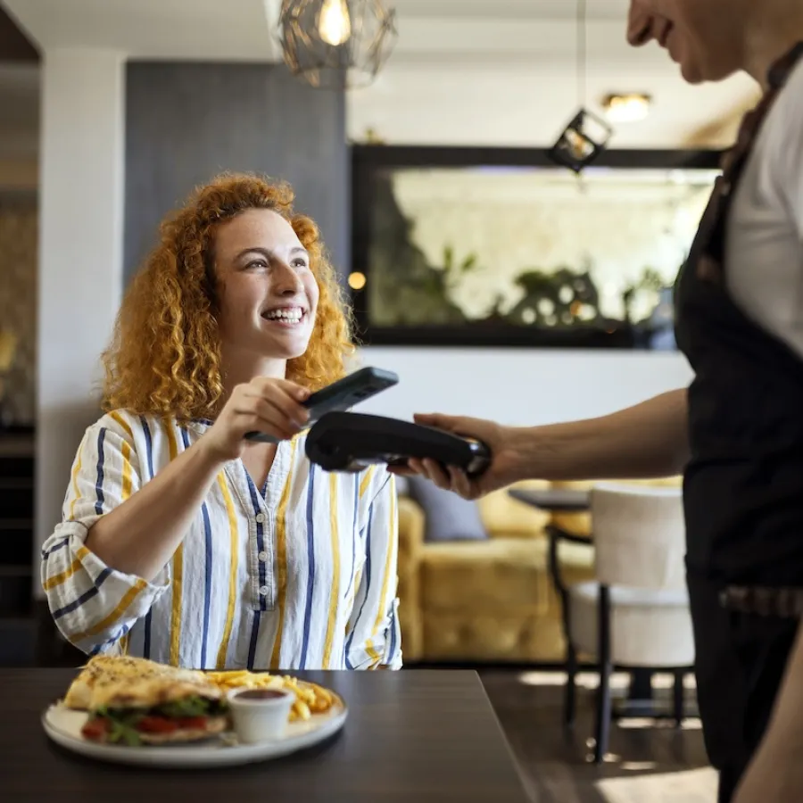 woman paying for meal with virtual card